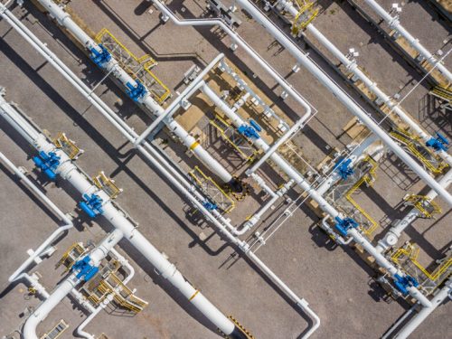 Aerial top view natural gas pipeline, gas industry, gas transport system, stop valves and appliances for gas pumping station.