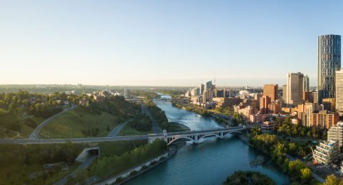 Aerial panoramic view of a beautiful modern cityscape during a vibrant sunny sunrise. Taken in Calgary Downtown, Alberta, Canada.